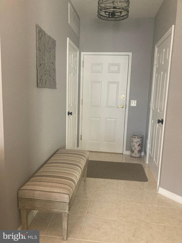 interior space with visible vents, baseboards, and tile patterned floors