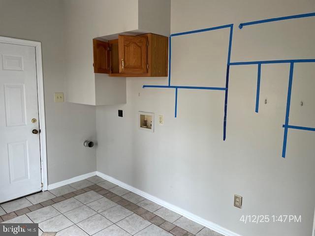 washroom with baseboards, cabinet space, hookup for a washing machine, and light tile patterned flooring