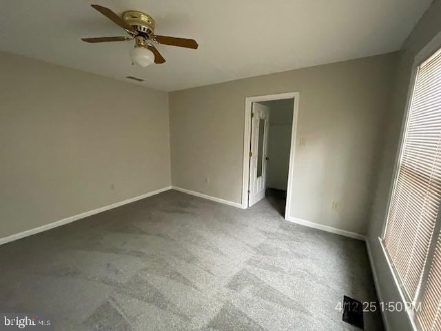 unfurnished bedroom featuring a ceiling fan, baseboards, and carpet