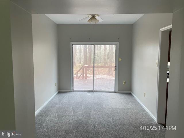 carpeted empty room with baseboards and a ceiling fan