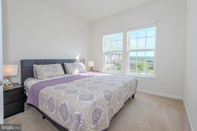 bedroom featuring baseboards and carpet flooring