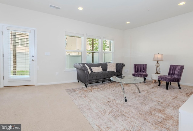 living area featuring recessed lighting, baseboards, visible vents, and carpet