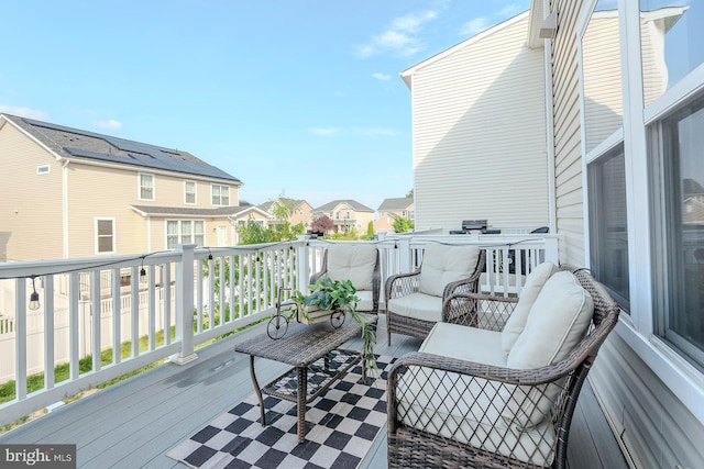 wooden deck featuring a residential view and an outdoor living space