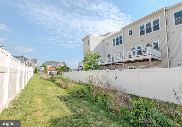 back of house with fence and a residential view