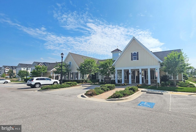 view of property with a residential view and uncovered parking