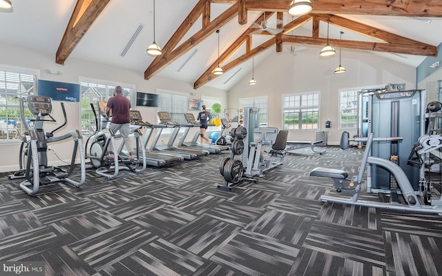 exercise room featuring baseboards, carpet flooring, visible vents, and high vaulted ceiling