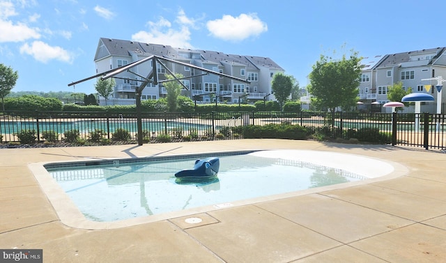 view of swimming pool with fence and a fenced in pool
