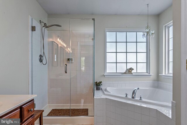 full bathroom with a stall shower, a garden tub, and vanity