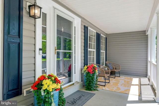 view of exterior entry featuring covered porch