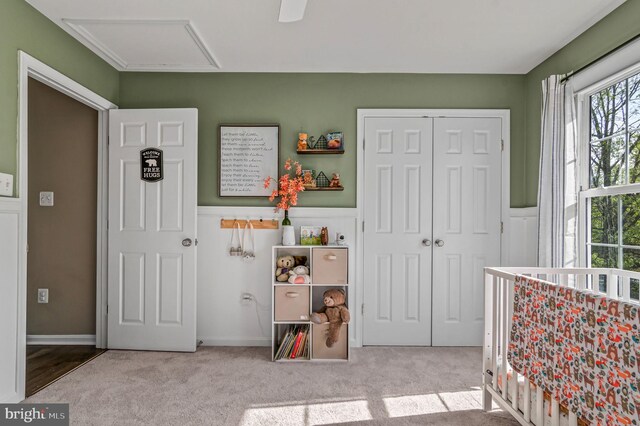 playroom with attic access, carpet flooring, and wainscoting
