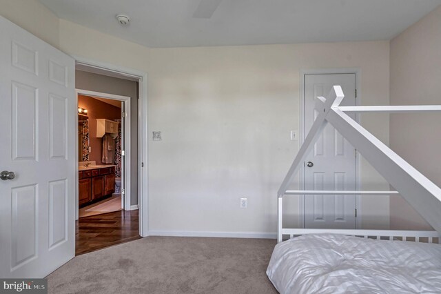 carpeted bedroom featuring baseboards