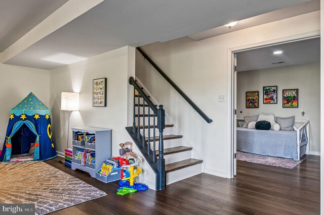recreation room featuring wood finished floors and baseboards