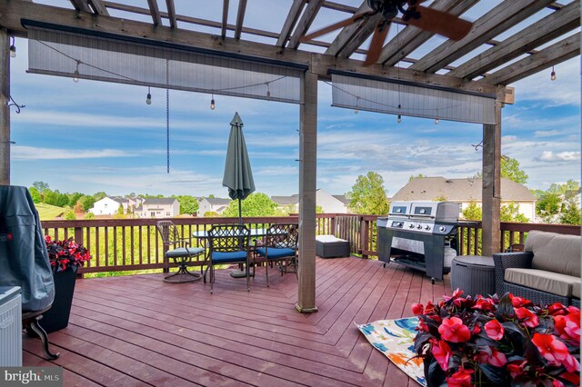 wooden deck featuring a pergola, a grill, and a residential view