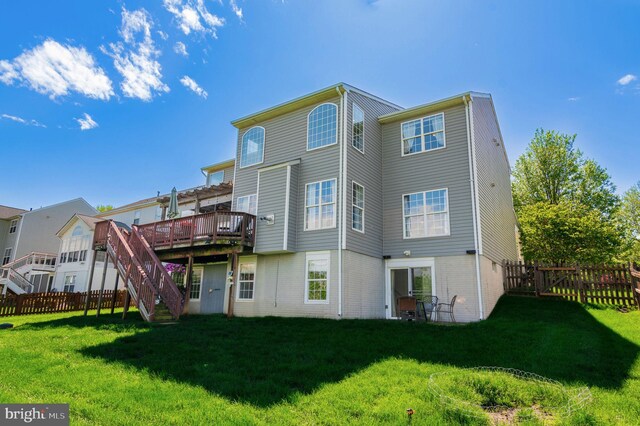 back of property with a wooden deck, stairway, and brick siding