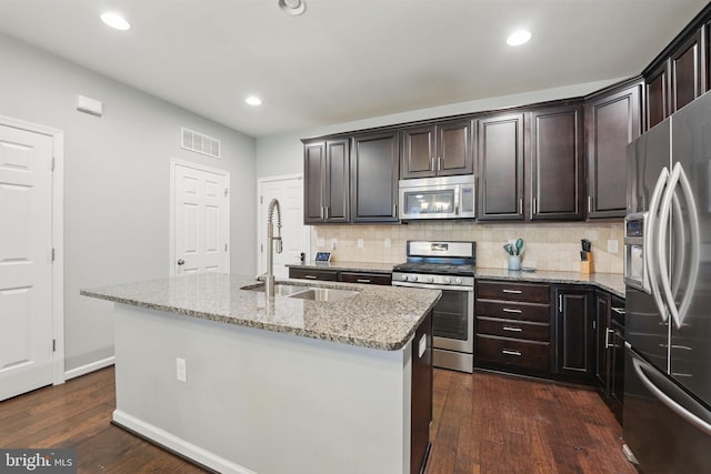 42783 Keiller Ter Unit 13A, Ashburn, VA 20147 - kitchen featuring stainless steel appliances, backsplash, light stone counters, dark wood-style flooring, and a kitchen island with sink