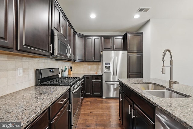 42783 Keiller Ter Unit 13A, Ashburn, VA 20147 - kitchen featuring stainless steel appliances, a sink, light stone counters, dark wood-style floors, and dark brown cabinetry