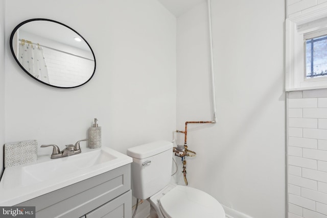 full bathroom with vanity and toilet