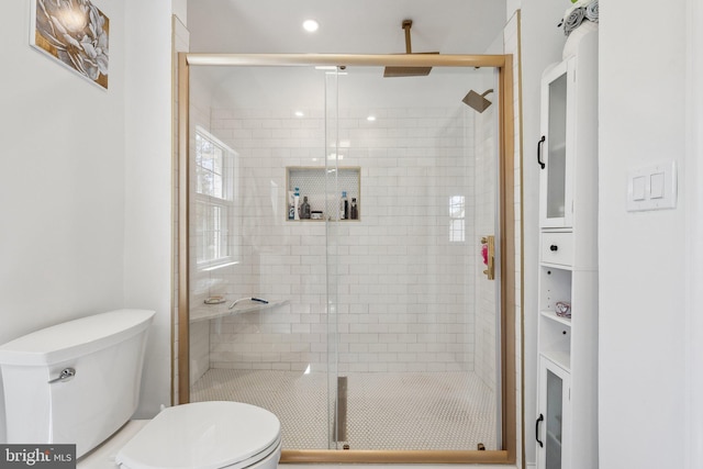 bathroom featuring recessed lighting, a stall shower, and toilet