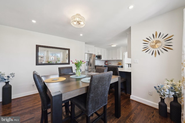 dining area with baseboards, recessed lighting, dark wood finished floors, and an inviting chandelier