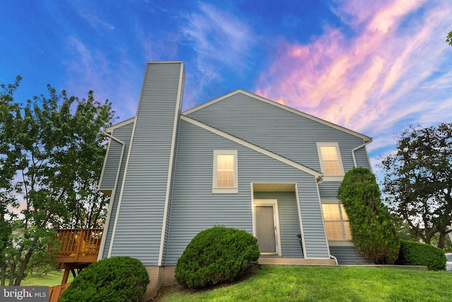 21700 Comstock Cir Unit 147, Sterling, VA 20164 - back of property at dusk featuring a yard and a chimney