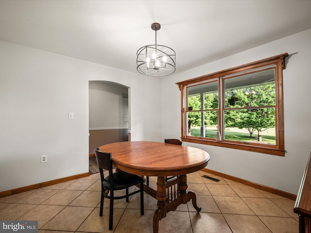 373 Thunder Hill Dr, Summit Point, WV 25446 - dining area with arched walkways, baseboards, light tile patterned floors, and a chandelier