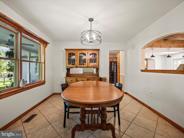373 Thunder Hill Dr, Summit Point, WV 25446 - dining area with light tile patterned floors, baseboards, and arched walkways