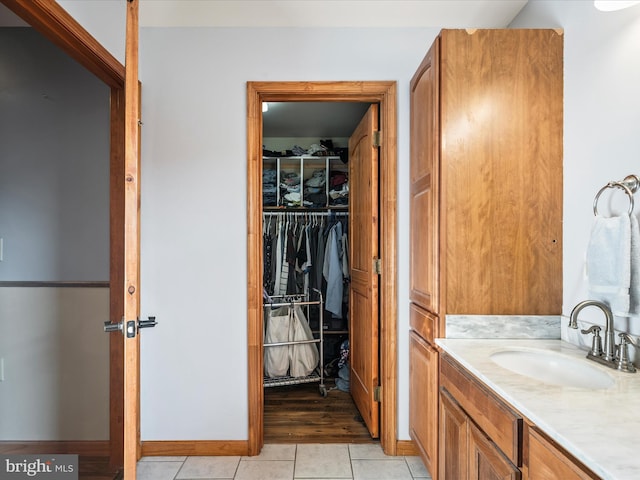 373 Thunder Hill Dr, Summit Point, WV 25446 - bathroom with vanity, tile patterned flooring, a spacious closet, and baseboards