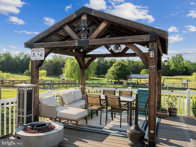373 Thunder Hill Dr, Summit Point, WV 25446 - wooden terrace featuring a gazebo, view of wooded area, a fire pit, and outdoor dining space