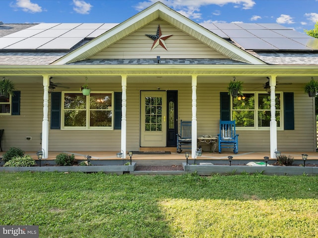 373 Thunder Hill Dr, Summit Point, WV 25446 - farmhouse with a ceiling fan, a porch, a front lawn, and roof mounted solar panels