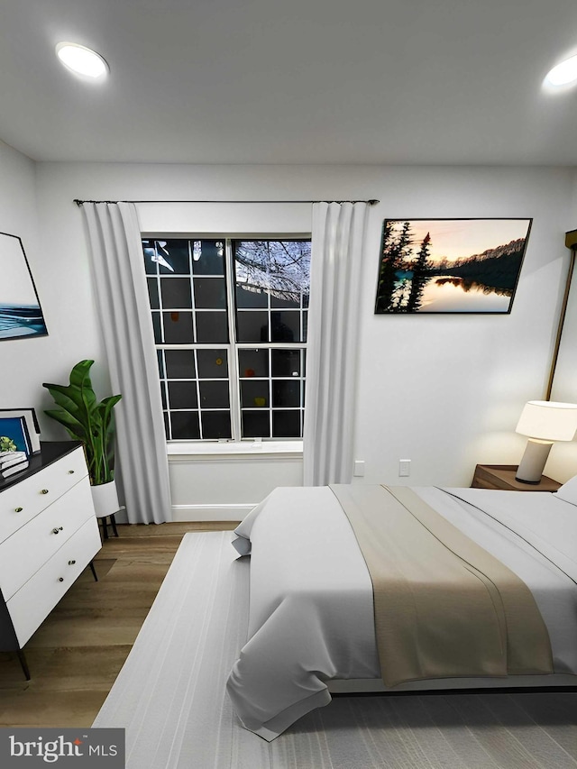 bedroom featuring recessed lighting and wood finished floors