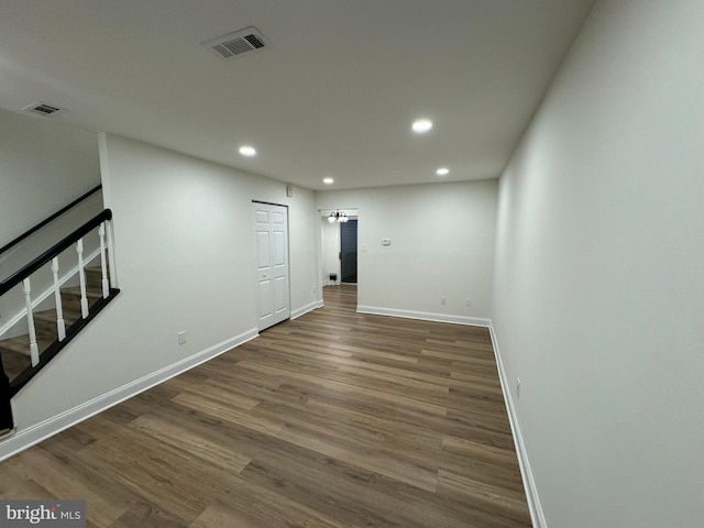 basement with recessed lighting, baseboards, wood finished floors, and visible vents