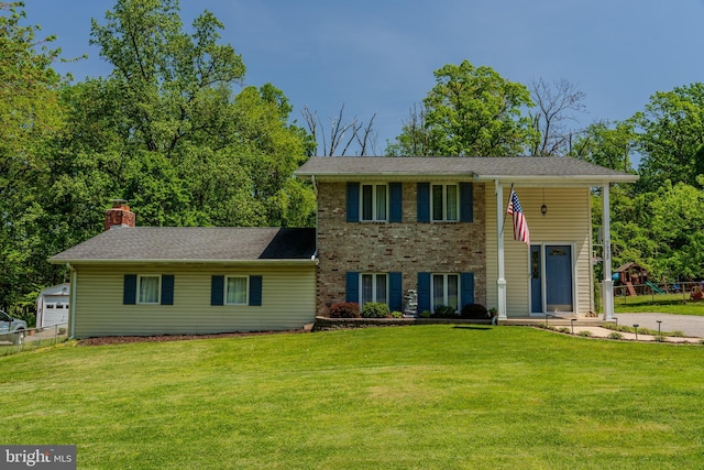 view of front of house with fence, a chimney, and a front lawn