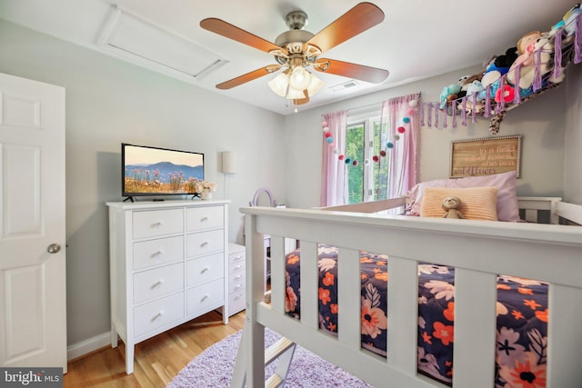 7925 Belhaven Ave, Pasadena, MD 21122 - bedroom with light wood-type flooring, attic access, ceiling fan, and baseboards