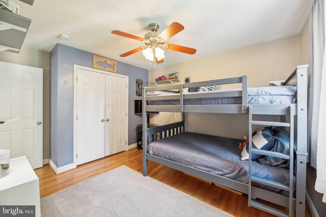 7925 Belhaven Ave, Pasadena, MD 21122 - bedroom featuring wood finished floors, a closet, baseboards, and ceiling fan