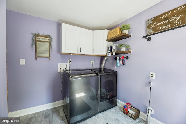 7925 Belhaven Ave, Pasadena, MD 21122 - laundry area with washing machine and clothes dryer, baseboards, cabinet space, and wood finished floors