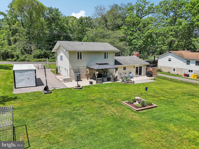 7925 Belhaven Ave, Pasadena, MD 21122 - back of property featuring a gazebo, a patio area, an outdoor hangout area, and a chimney
