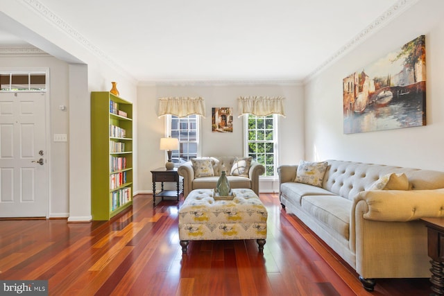 living room featuring dark wood finished floors, ornamental molding, and baseboards
