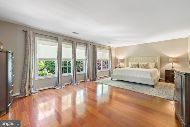 bedroom with wood finished floors and baseboards