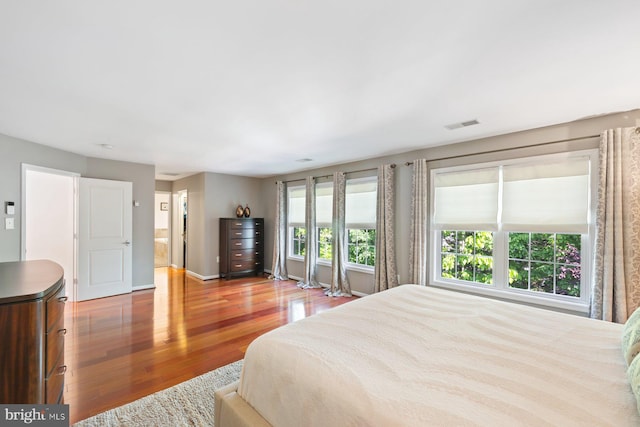 bedroom with wood finished floors and baseboards