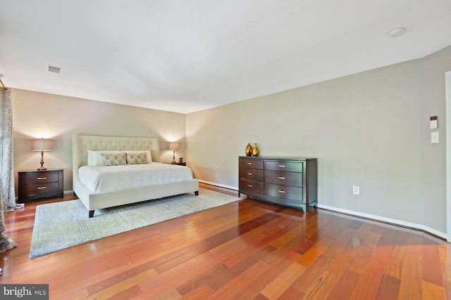 bedroom with wood finished floors and baseboards