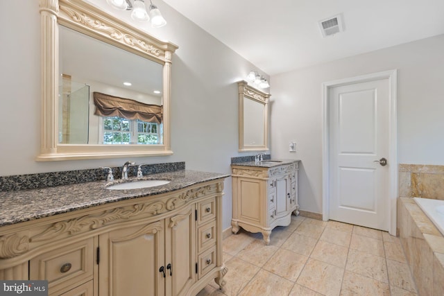 bathroom featuring a garden tub, two vanities, and baseboards