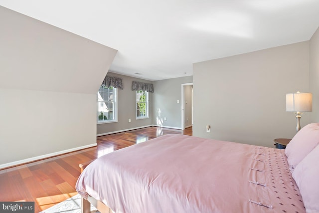 bedroom featuring wood finished floors and baseboards