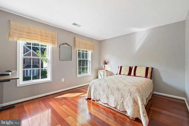 bedroom with baseboards and wood-type flooring
