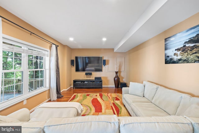 living room featuring wood finished floors, baseboards, and recessed lighting