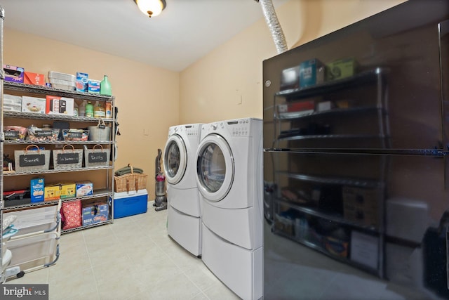 washroom with washer and clothes dryer and light tile patterned floors