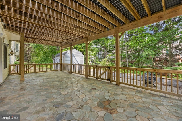 view of patio / terrace featuring a storage unit and an outdoor structure