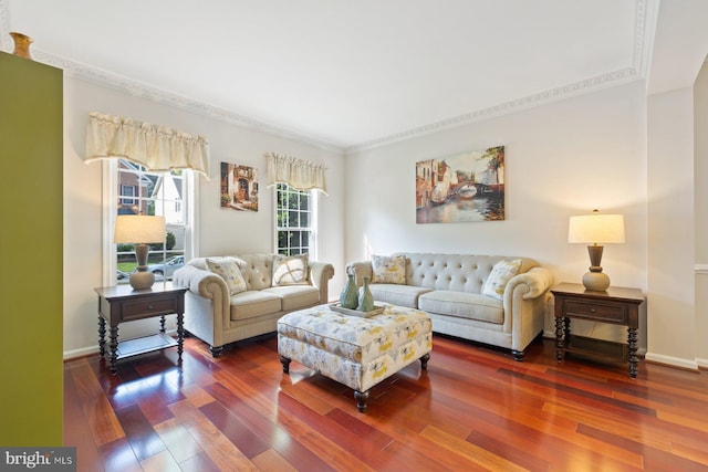 living room featuring wood finished floors, ornamental molding, and baseboards