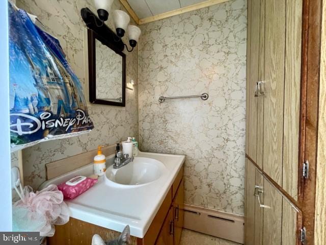 bathroom featuring vanity, a baseboard radiator, and wallpapered walls
