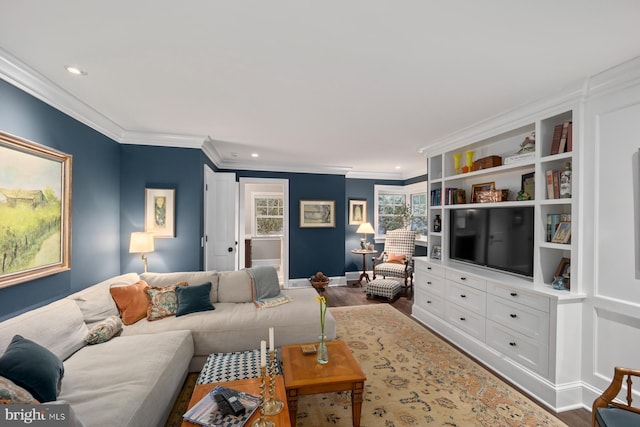 living room featuring ornamental molding, wood finished floors, baseboards, and recessed lighting