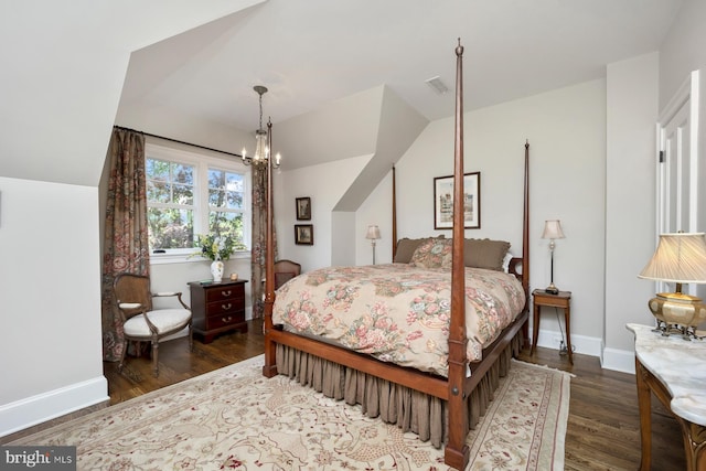 bedroom featuring wood finished floors, baseboards, a chandelier, and vaulted ceiling
